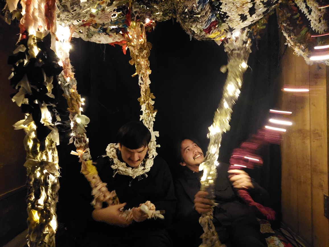 Photo of what remains with two visitors interacting